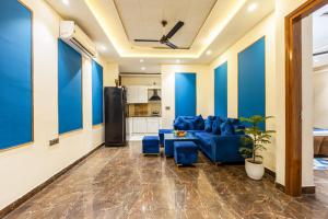 a living room with blue walls and a blue couch at Bnb Sakura , Golf Course Road in Gurgaon +132 photos