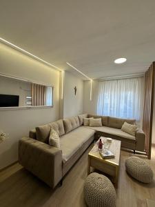 a living room with a couch and a table at Apartman Centar - Posušje in Posušje