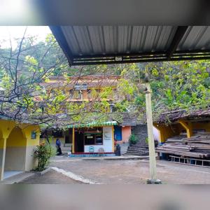 a building with a group of buildings with stairs and a pole at Baron Sari Homestay in Pulau Kukup