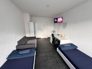 En eller flere senge i et værelse på Hotelikum Zentral Günstig