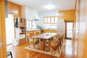 a kitchen with a table and chairs in it at Nagoya in Nakijin +27 photos