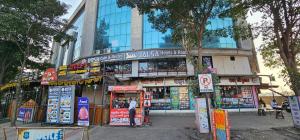 a building with a lot of signs in front of it at Hotel Jalsa in Surat