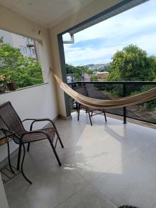a hammock on the balcony of a house at Doce aconchego in Pato Branco