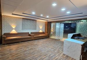 a large room with couches and a television in it at Hotel Park View in Akolia