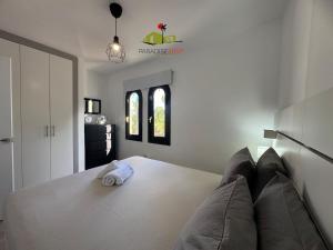a bedroom with a bed with a pillow on it at Casa Dudu in Corralejo +19 photos