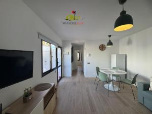 a living room with a tv and a table and chairs at Casa Dudu in Corralejo