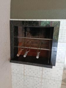 a rack with cooking utensils on top of a fireplace at Doce aconchego in Pato Branco +5 photos