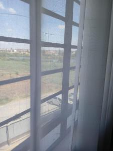 a view of a window with a view of a field at Beijing Nest in Syokimau