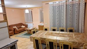 a living room with a table and chairs and a couch at Kuća za odmor Diva Blidinje, Risovac 455 in Blidinje