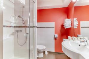 a bathroom with a shower and a toilet and a sink at Ace Hotel Montluçon in Saint-Victor +16 photos
