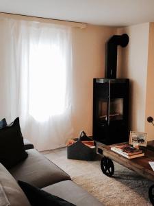 a living room with a couch and a fireplace at Ferienhaus Grüner Heinrich in Andermatt +5 photos