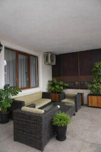 a patio with couches and plants in a building at Hotel New Terrace in Tbilisi City