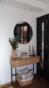a mirror sitting on top of a table with a shelf at Durmitor Sunstone in Žabljak