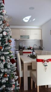 a christmas tree in a kitchen with a table and chairs at Durmitor Sunstone in Žabljak
