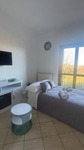 a bedroom with two beds and a table and a tv at Harmony Boutique inn in Bassano Romano +34 photos