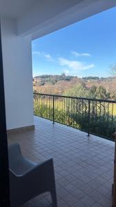 a room with a balcony with a view of a field at Harmony Boutique inn in Bassano Romano