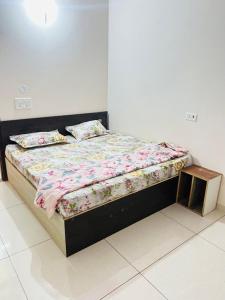 a bedroom with a bed with a wooden frame at New hotel Arjun place, Reengus in Rīngas