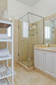 a bathroom with a glass shower and a sink at VESTA - El Gouna Residence in Hurghada