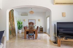 a living room with a table and a tv at VESTA - El Gouna Residence in Hurghada