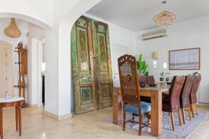 a dining room with a table and a large door at VESTA - El Gouna Residence in Hurghada