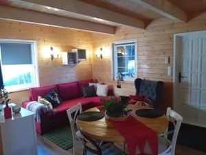 a living room with a red couch and a table at Black&White-Cherry in Kołczewo