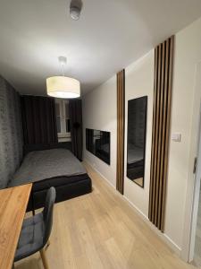 a bedroom with a bed and a dining room table at Panorama Premium Plac Jana z Głogowa 2 in Głogów