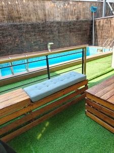 an empty bench in front of a swimming pool at Boho apartment and spa in Lekki +9 photos