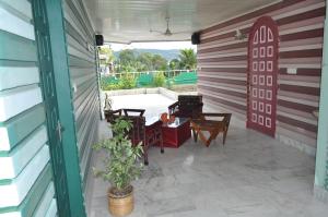 a patio with a table and chairs in a building at Saikia Nest the Home-stay in Guwahati