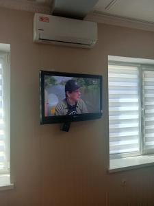 a flat screen tv hanging on a wall at Современная студия-люкс, слобожанській in Samarovka +5 photos
