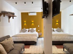 En eller flere senge i et værelse på Hotel B&B Nativo Peñón