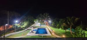 een zwembad in een park 's nachts bij Riverside Farm in Murud