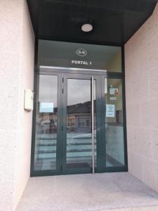 a front door of a building with a sign on it at Atico Finisterre in Fisterra