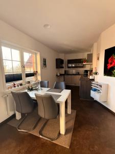 eine Küche und ein Esszimmer mit Tisch und Stühlen in der Unterkunft Ferienwohnung Seetalblick in Geiselberg