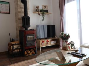 a living room with a television and a glass table at Durmitor Sunstone in Žabljak