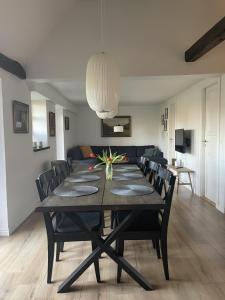 a dining room with a table and chairs at Baekgaarden 3 rooms Apartment - old farm house in Odense +14 photos