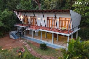 an overhead view of a house with a balcony at EKOSTAY - Forest Cube Villa in Attigundi