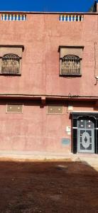 un edificio in mattoni rossi con due finestre e una porta di Luxury Guest House ad Agadir