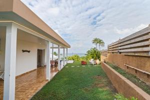 an external view of a house with a lawn at Villa Calaïa in Tartane