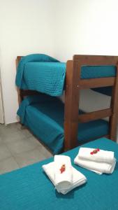 ein Zimmer mit einem Etagenbett und Handtüchern auf einem Tisch in der Unterkunft Departamento CR in Alta Gracia