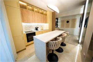 a kitchen with a white counter in a room at Royal Luxury Suite in Iaşi