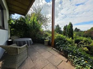 a patio with a table and chairs on a patio at Ferienwohnung Smutje in Kiel +11 photos