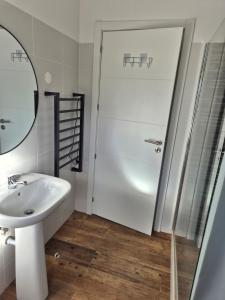 ein Badezimmer mit Dusche, Waschbecken und Spiegel in der Unterkunft Flat near Serra da Arrábida, beaches and Lisbon in Quinta do Conde + 7 Fotos