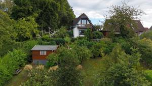 a house sitting on top of a hill with trees at Ferienwohnung Smutje in Kiel