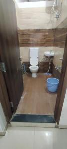 a bathroom with a toilet and a sink at jp hotel and restorent in Rīngas
