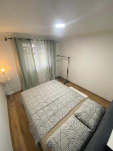 a small bedroom with a bed in a room at Vikendica Zeleni san in SJJ