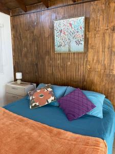 a bed with two pillows on top of it at Loft Tongoy 2 Interior sin vista al mar in Tongoy