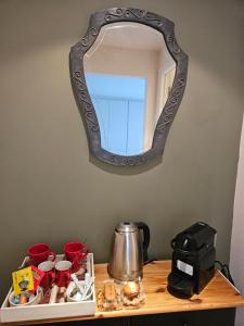 a mirror hanging on a wall above a wooden table at Brigitte & Alain in Brussels