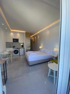 a large bedroom with a bed and a kitchen at Panoramic View Boutique Suite in Rethymno