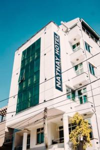 a white building with a sign on the side of it at Nathay Hotel in Addis Ababa Bole International Airport