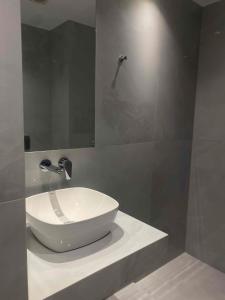 a bathroom with a white bowl sink on a counter at Panoramic View Boutique Suite in Rethymno